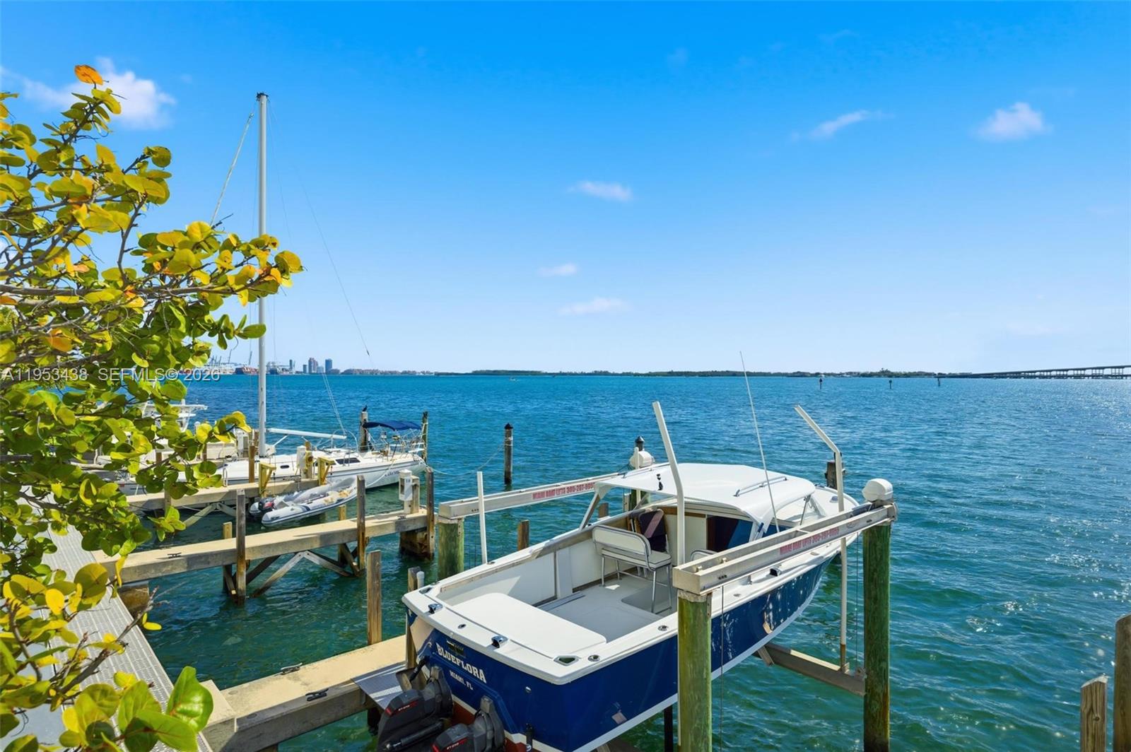 200 Southeast 15th Road, Unit 11H Miami, FL 33129 - Photo 20 of 25 a roof deck with table and chairs and potted plants