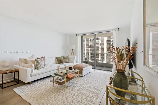 a living room with furniture and a floor to ceiling window