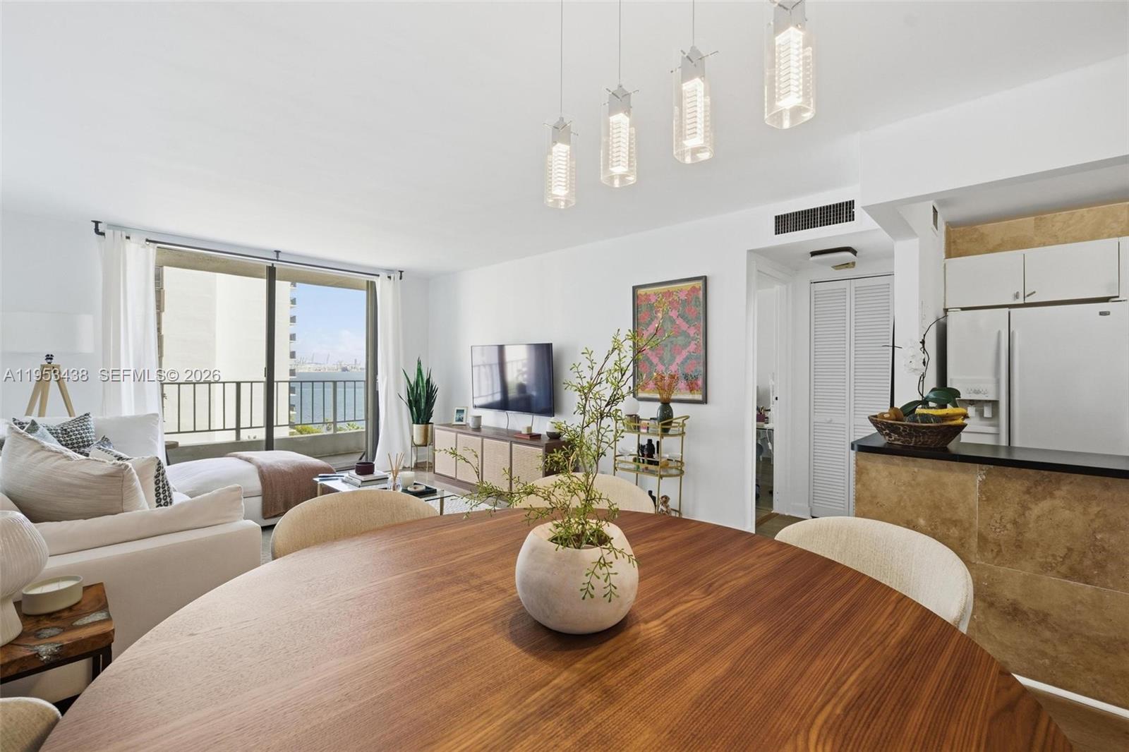 200 Southeast 15th Road, Unit 11H Miami, FL 33129 - Photo 6 of 25 a living room with furniture and a large window