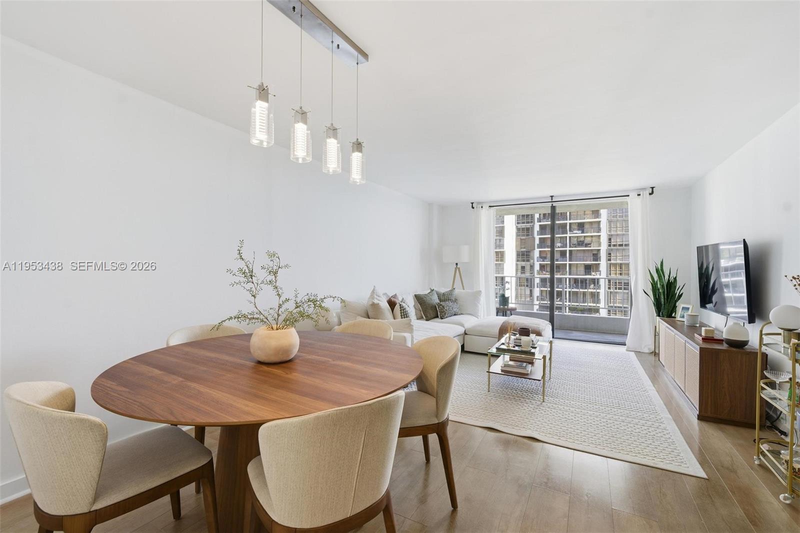 200 Southeast 15th Road, Unit 11H Miami, FL 33129 - Photo 7 of 25 a view of a dining room with furniture window and wooden floor