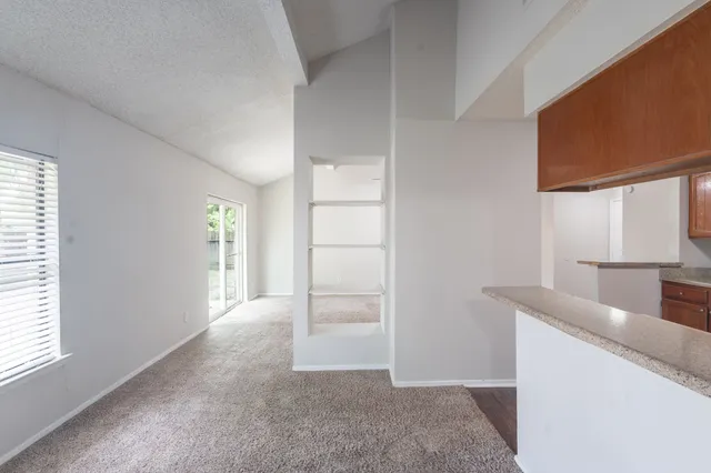 a view of a kitchen cabinets and a window