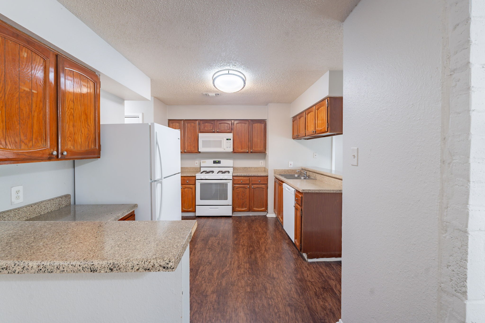 2302 Peaceful Valley Drive Spring, TX 77373 - Photo 13 of 39 a kitchen with stainless steel appliances granite countertop a stove a sink and a refrigerator