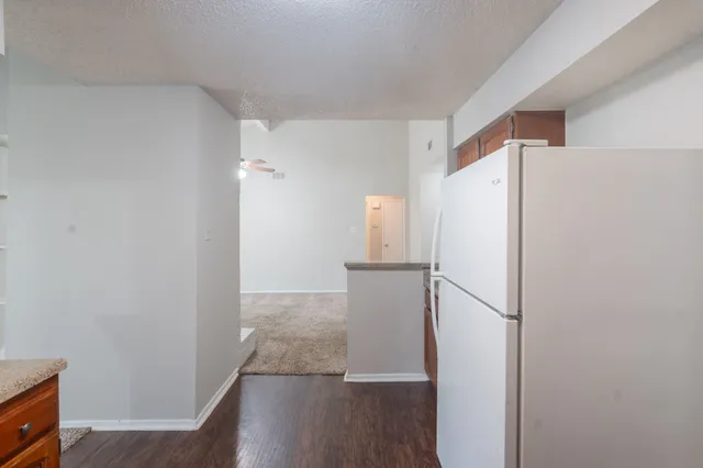 a kitchen with stainless steel appliances granite countertop a refrigerator a stove a sink and a microwave