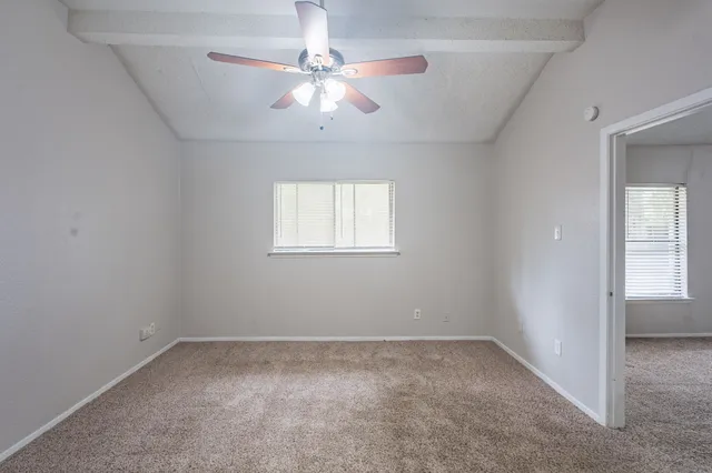 an empty room with a empty space and a ceiling fan