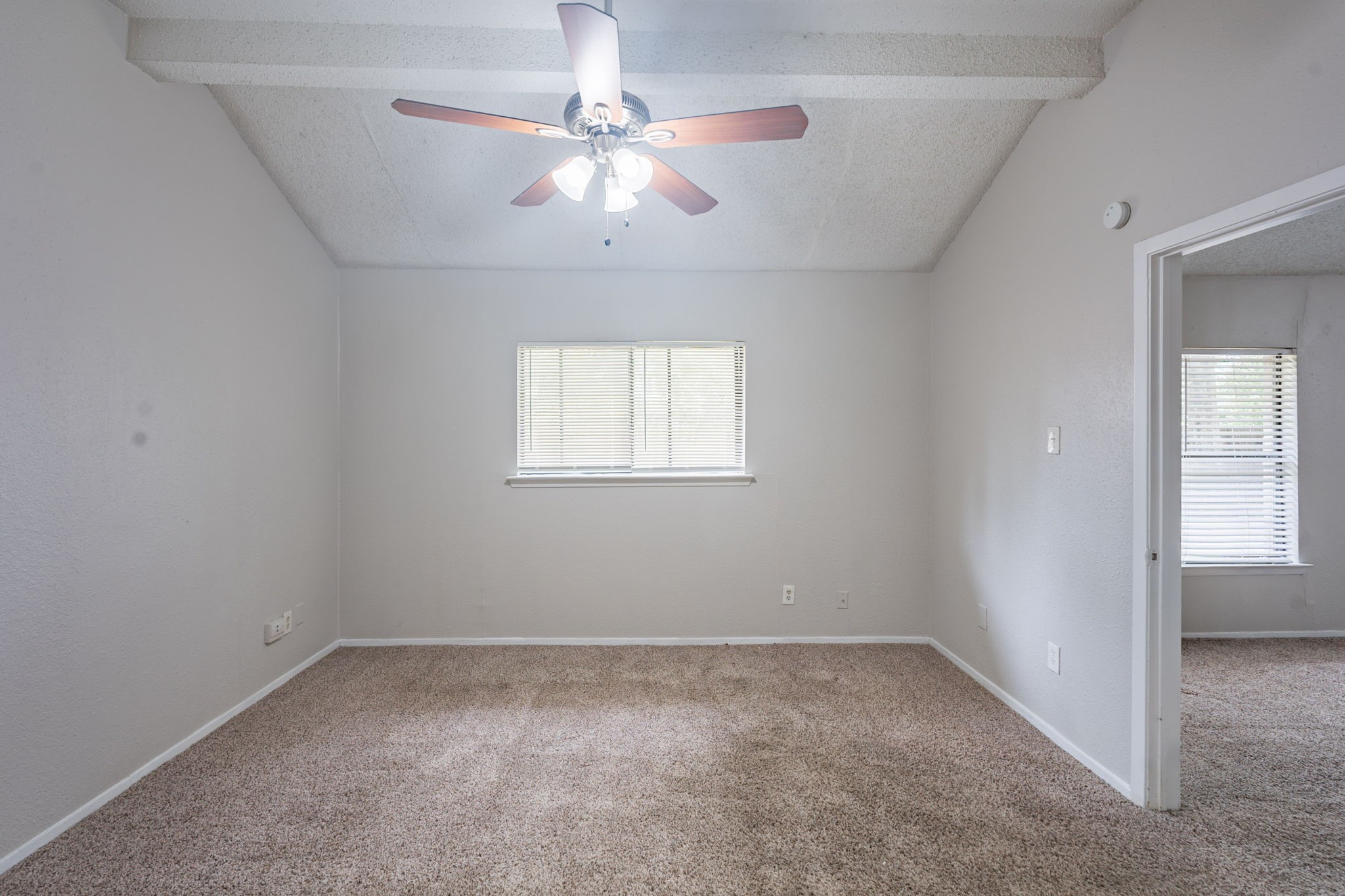 2302 Peaceful Valley Drive Spring, TX 77373 - Photo 18 of 39 an empty room with a chandelier fan and windows