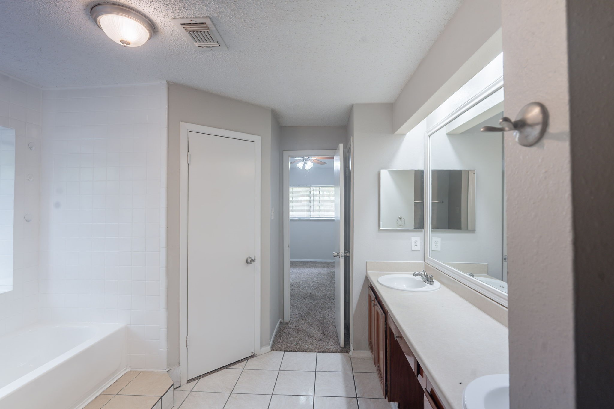 2302 Peaceful Valley Drive Spring, TX 77373 - Photo 22 of 39 a bathroom with a double vanity sink a mirror and a bathtub
