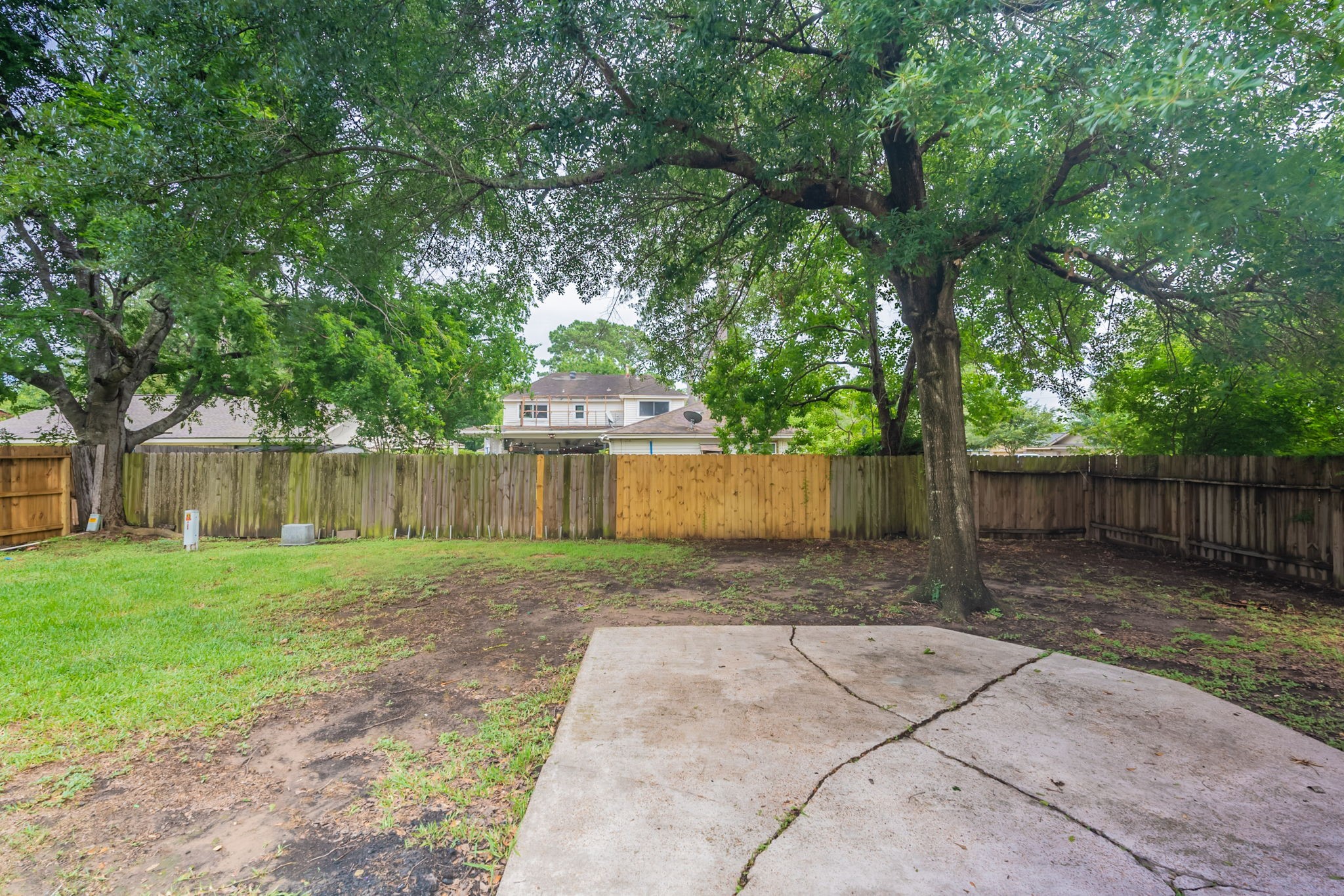 2302 Peaceful Valley Drive Spring, TX 77373 - Photo 34 of 39 a view of a backyard with large trees and wooden fence