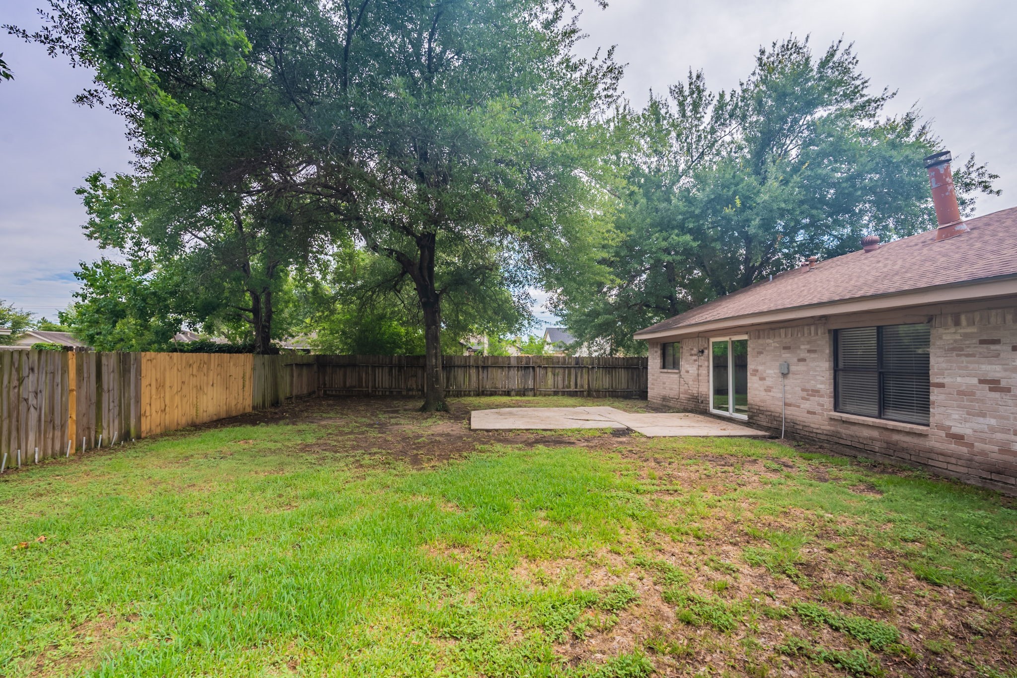 2302 Peaceful Valley Drive Spring, TX 77373 - Photo 37 of 39 a backyard of a house with table and chairs