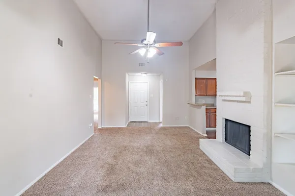 a room with wooden floor and a lamp