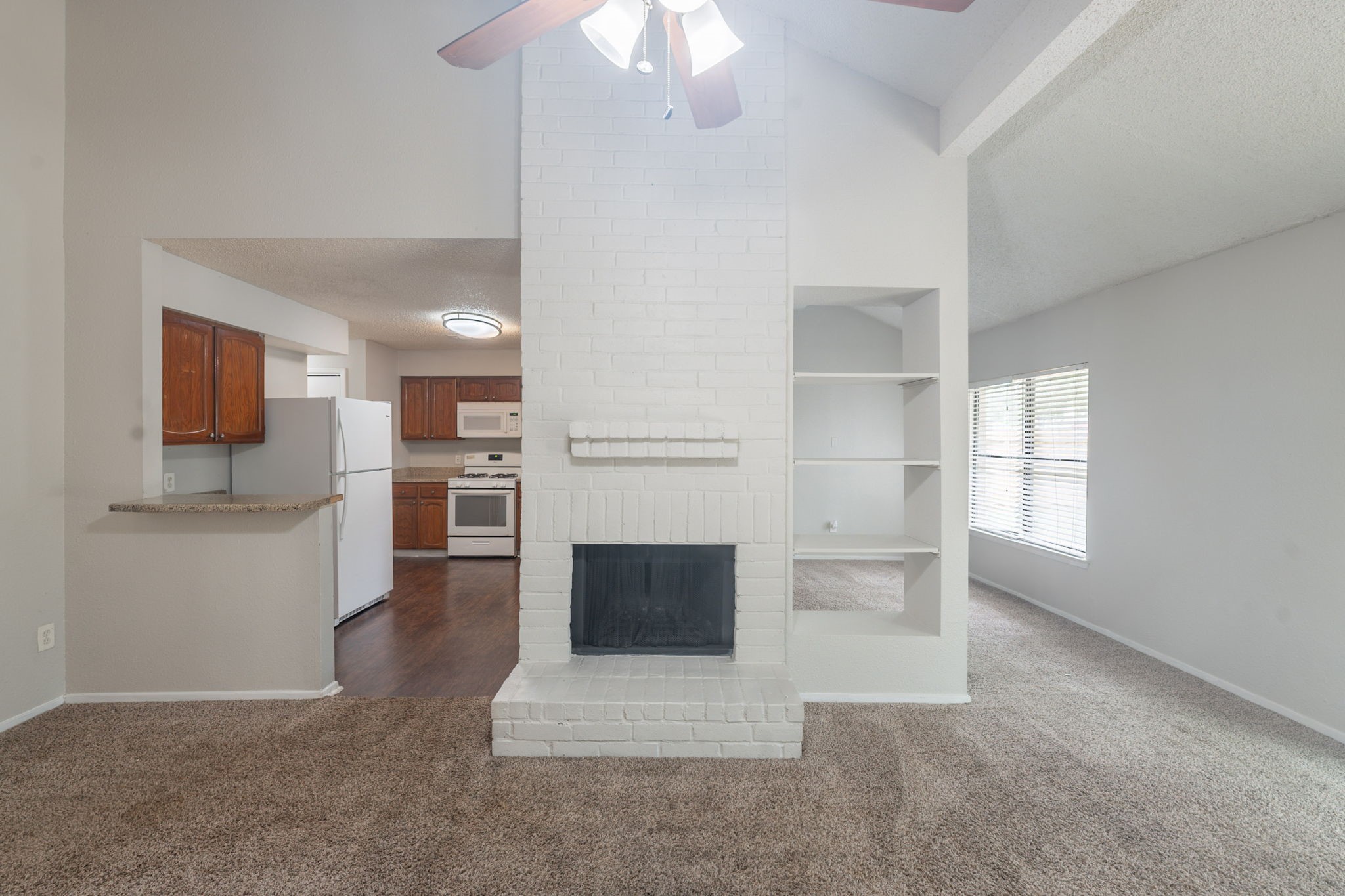 2302 Peaceful Valley Drive Spring, TX 77373 - Photo 9 of 39 a living room with furniture a flat screen tv and kitchen view