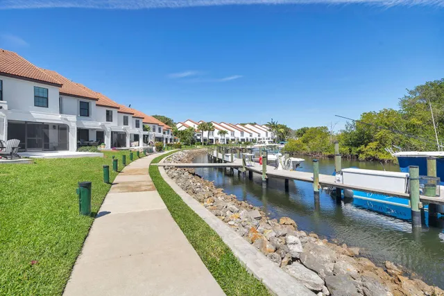 an aerial view of residential houses with outdoor space and swimming pool