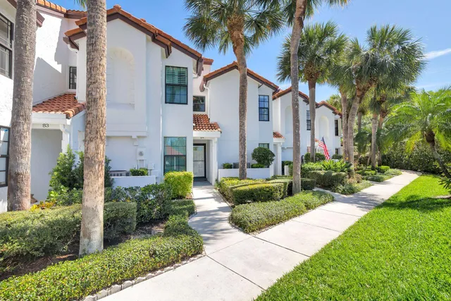 a green field with trees in the background
