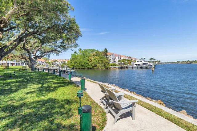 a view of a big house with a big yard and large trees