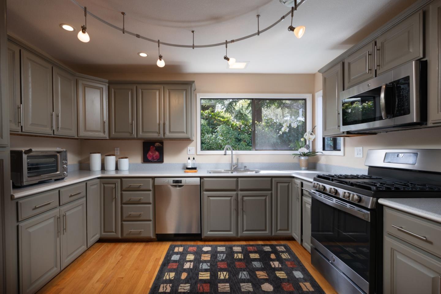 3060 Aztec Road Pebble Beach, CA 93953 - Photo 11 of 38 a kitchen with stainless steel appliances granite countertop white cabinets granite counter tops and a window