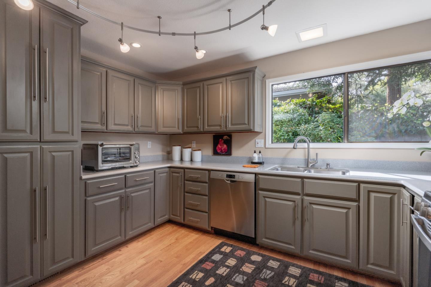3060 Aztec Road Pebble Beach, CA 93953 - Photo 14 of 38 a kitchen with a sink window and cabinets