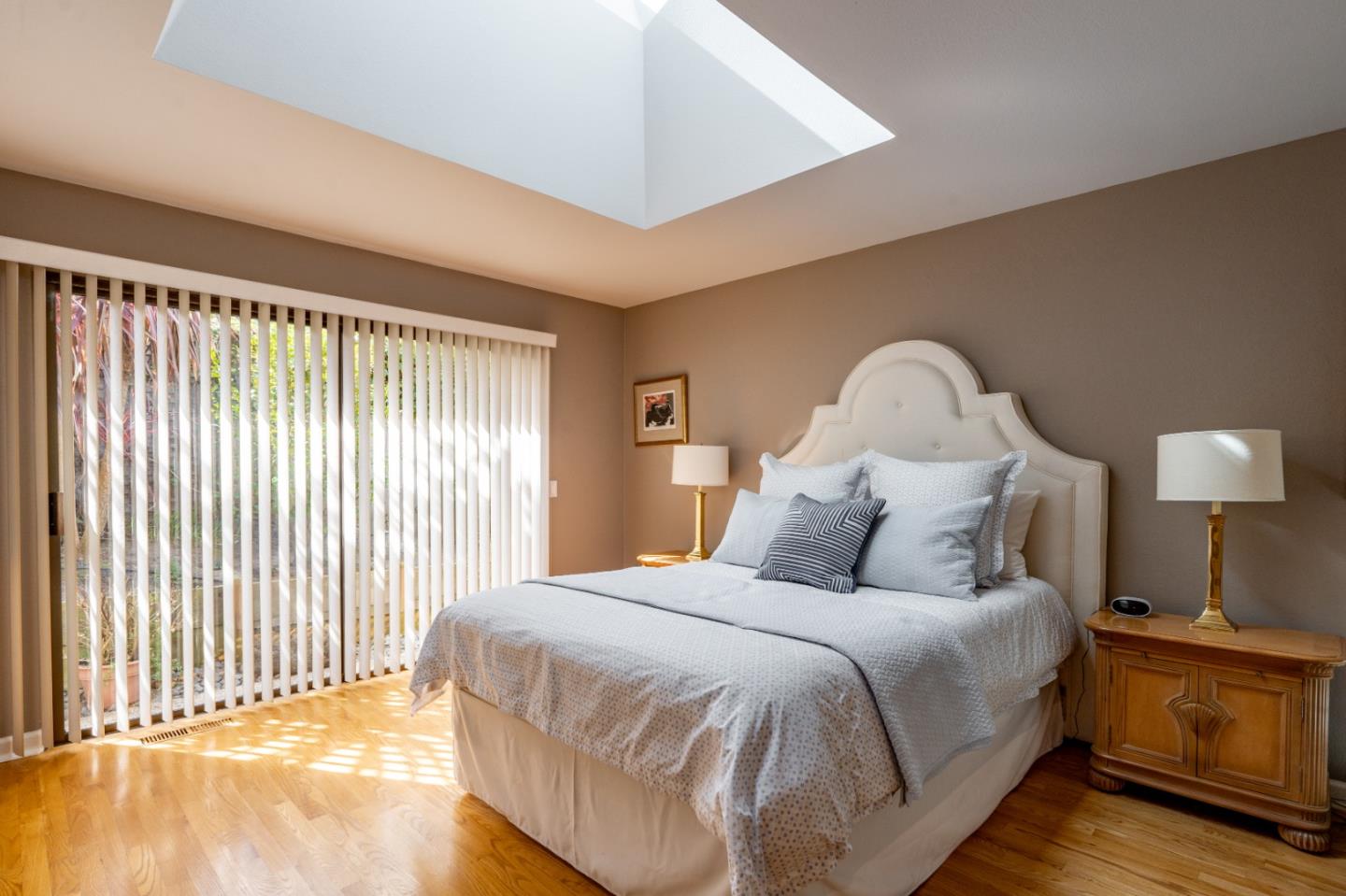 3060 Aztec Road Pebble Beach, CA 93953 - Photo 22 of 38 a large bed sitting in a bedroom next to a lamp and a large window