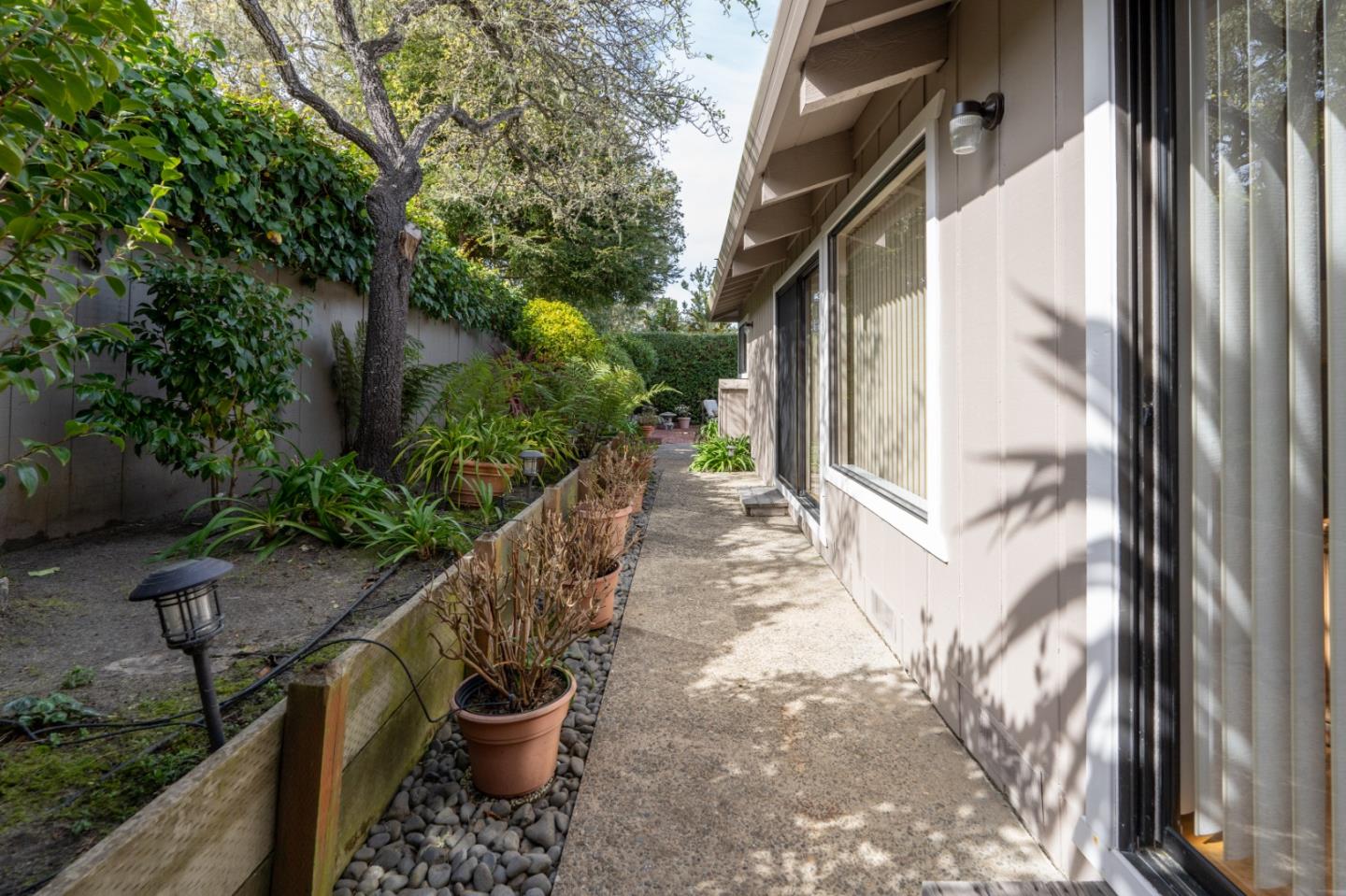 3060 Aztec Road Pebble Beach, CA 93953 - Photo 33 of 38 a view of a balcony with chair and potted plants