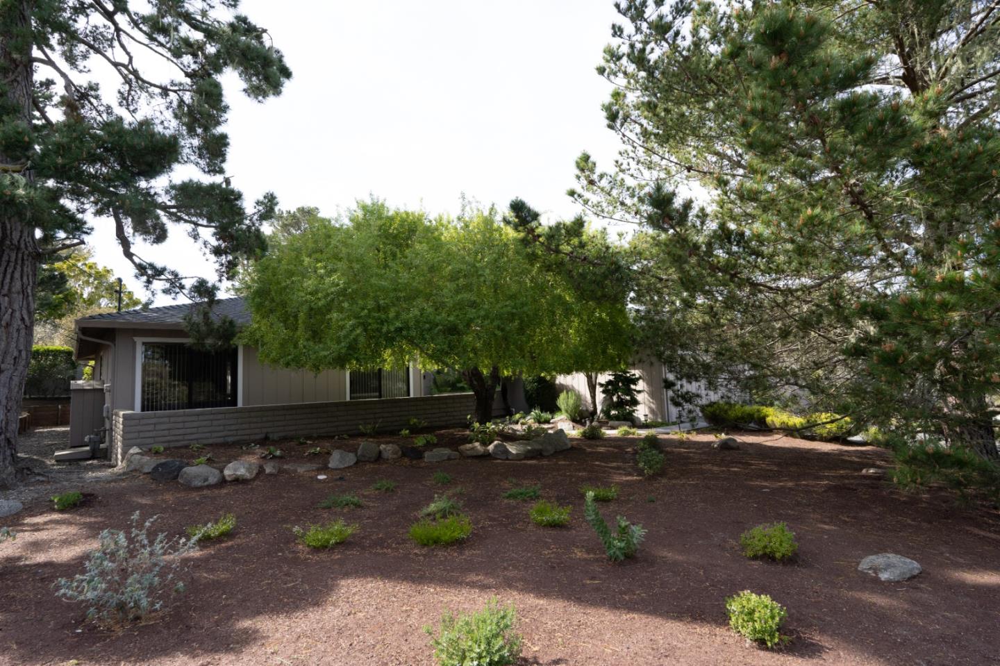 3060 Aztec Road Pebble Beach, CA 93953 - Photo 34 of 38 a backyard of a house with lots of green space