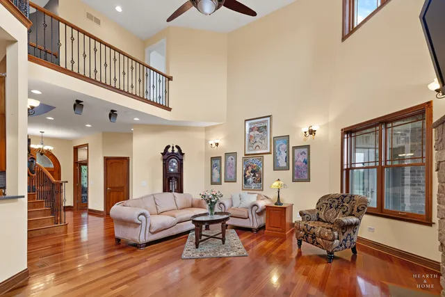 a view of a balcony with chairs and wooden floor