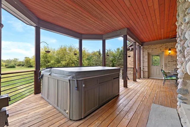 a spacious bedroom with a bed and a chandelier