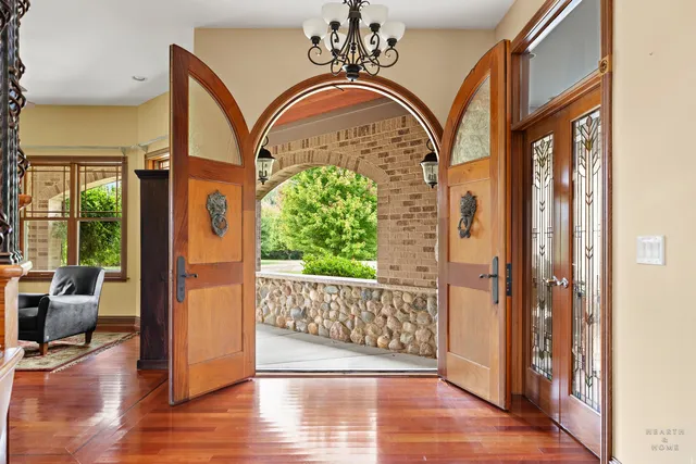 a kitchen with stainless steel appliances granite countertop a stove and a wooden floors