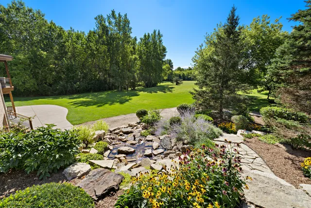 a view of a house with a yard and sitting area