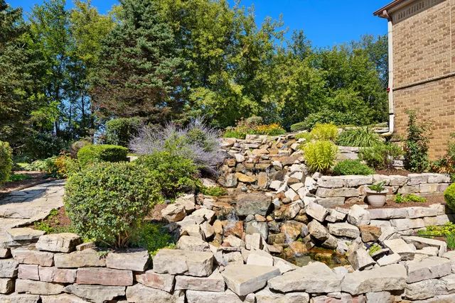 a view of a house with a yard and garden