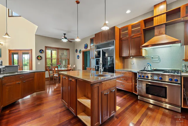a living room with furniture two window and wooden floor