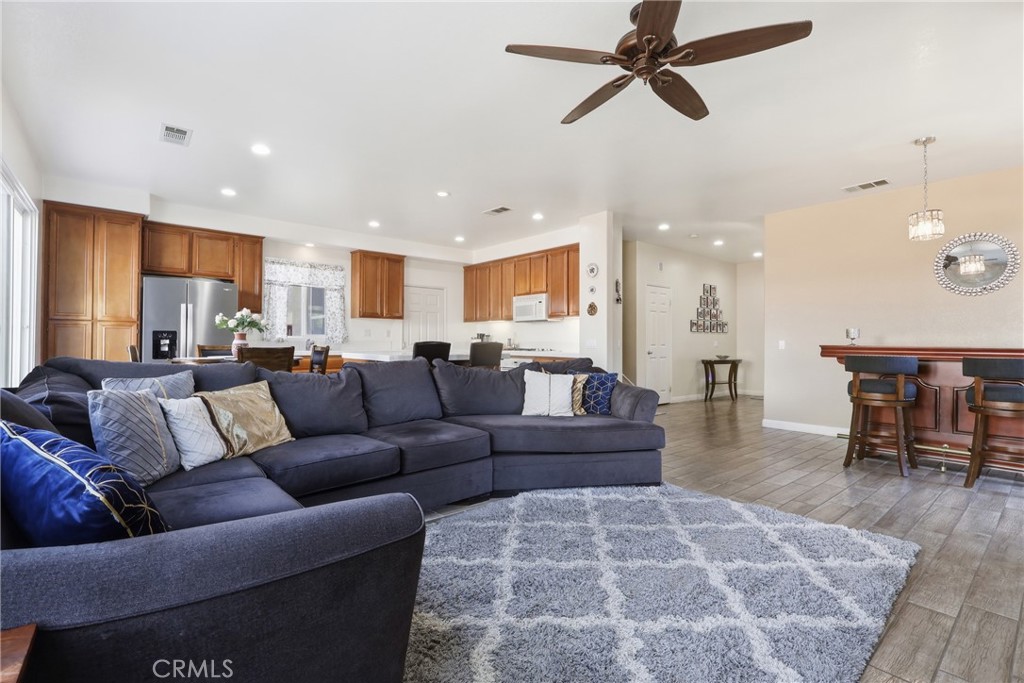 3609 Pyramid Trail Perris, CA 92570 - Photo 11 of 40 a living room kitchen with a couch and a dining table
