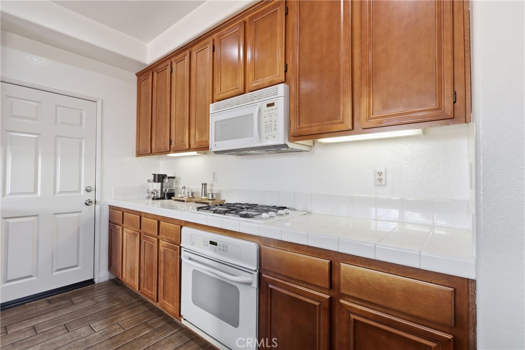 3609 Pyramid Trail Perris, CA 92570 - Photo 14 of 40 a kitchen with stainless steel appliances granite countertop a sink a stove and cabinets