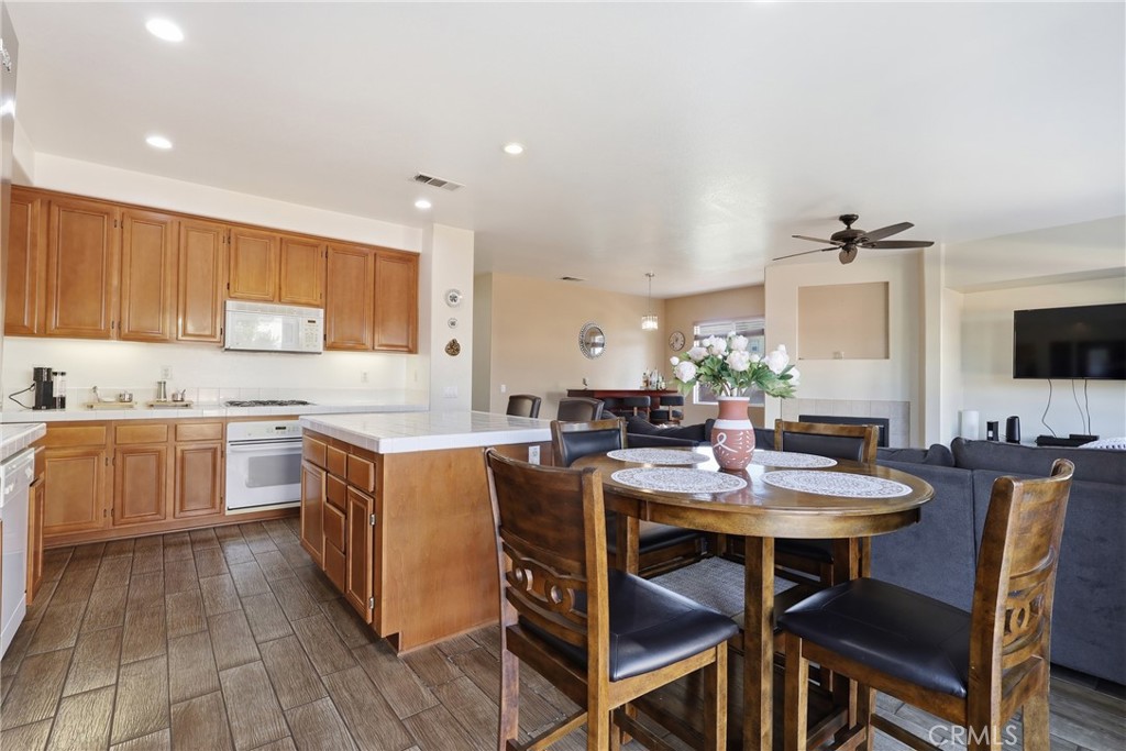 3609 Pyramid Trail Perris, CA 92570 - Photo 17 of 40 a kitchen with a table chairs stove and cabinets
