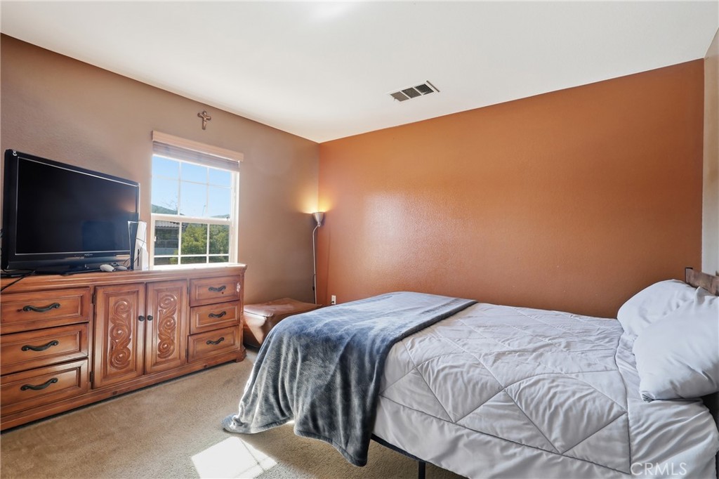 3609 Pyramid Trail Perris, CA 92570 - Photo 21 of 40 a bedroom with a bed and flat screen tv