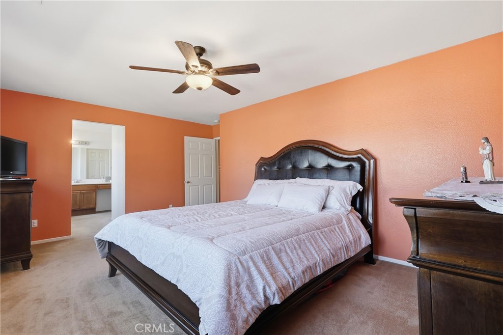 3609 Pyramid Trail Perris, CA 92570 - Photo 22 of 40 a bedroom with a bed and a ceiling fan