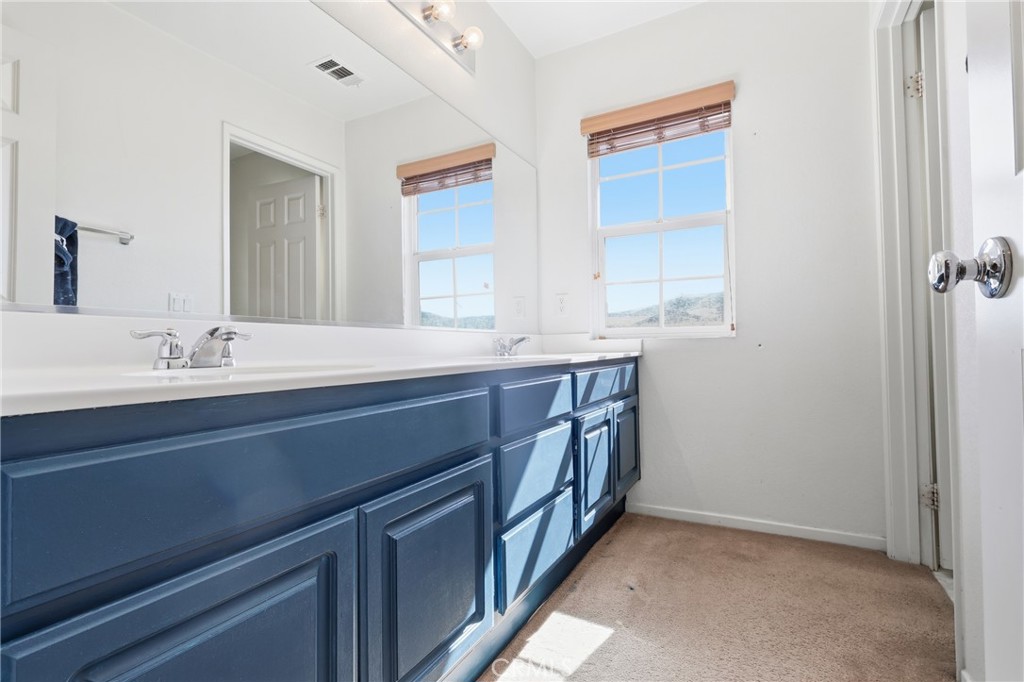 3609 Pyramid Trail Perris, CA 92570 - Photo 25 of 40 a bathroom with a sink and a mirror