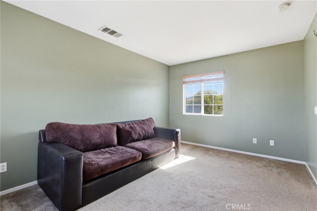 3609 Pyramid Trail Perris, CA 92570 - Photo 31 of 40 a living room with a couch and a window
