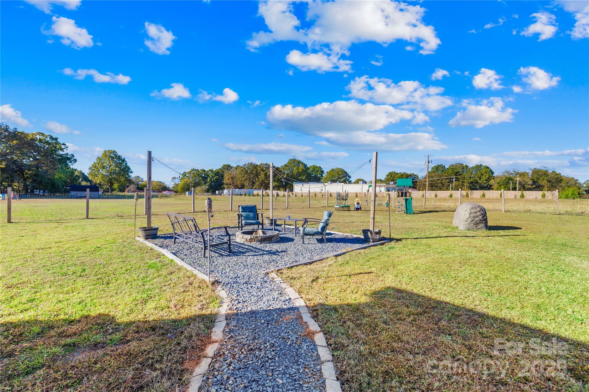 31321 Garrett Way Albemarle, NC 28001 - Photo 15 of 21 a view of a swimming pool with an outdoor seating and a yard
