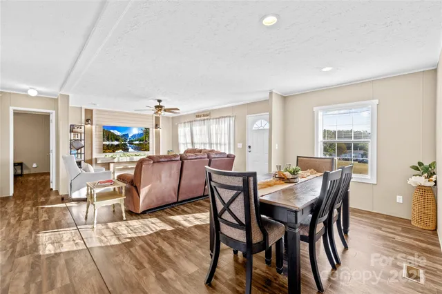 a dining room with furniture and wooden floor