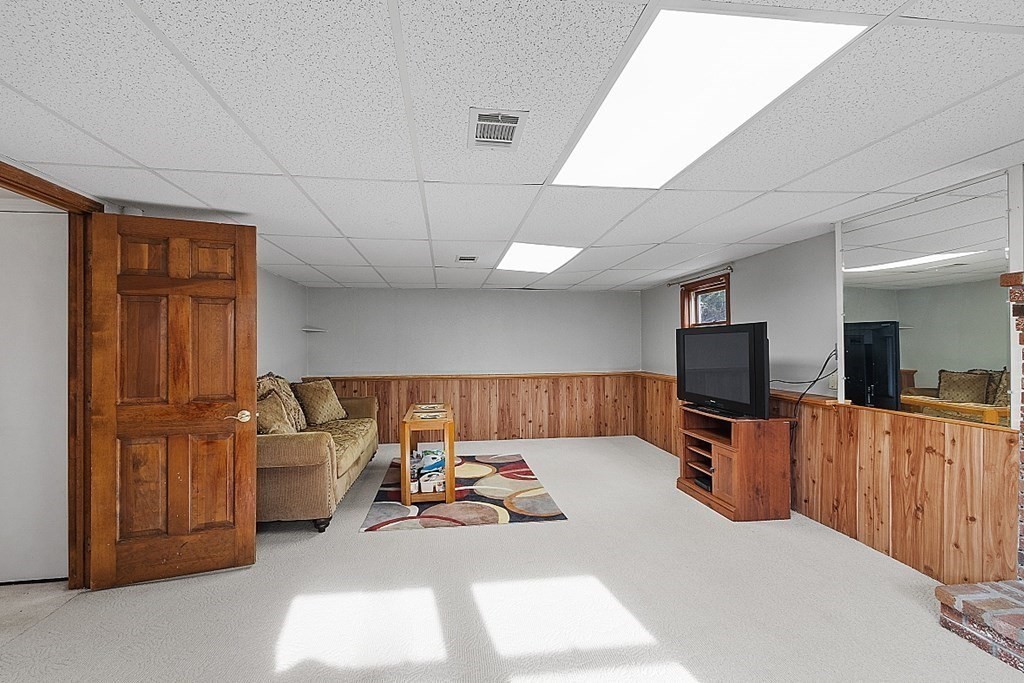 97 Riverview Boulevard Methuen, MA 01844 - Photo 17 of 30 a living room with furniture and a flat screen tv