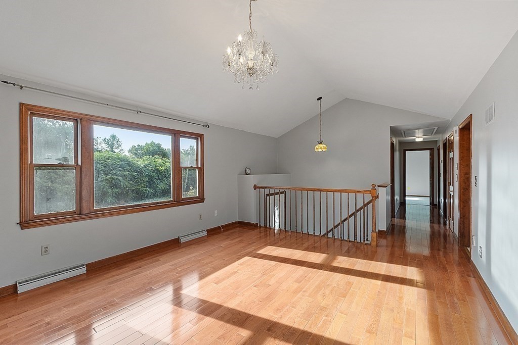 97 Riverview Boulevard Methuen, MA 01844 - Photo 4 of 30 a view of an empty room with wooden floor and a window