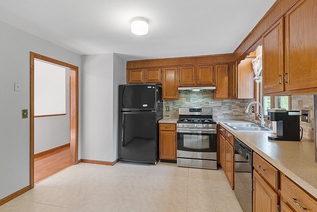 97 Riverview Boulevard Methuen, MA 01844 - Photo 7 of 30 a kitchen with stainless steel appliances granite countertop a refrigerator a stove and a sink with cabinets