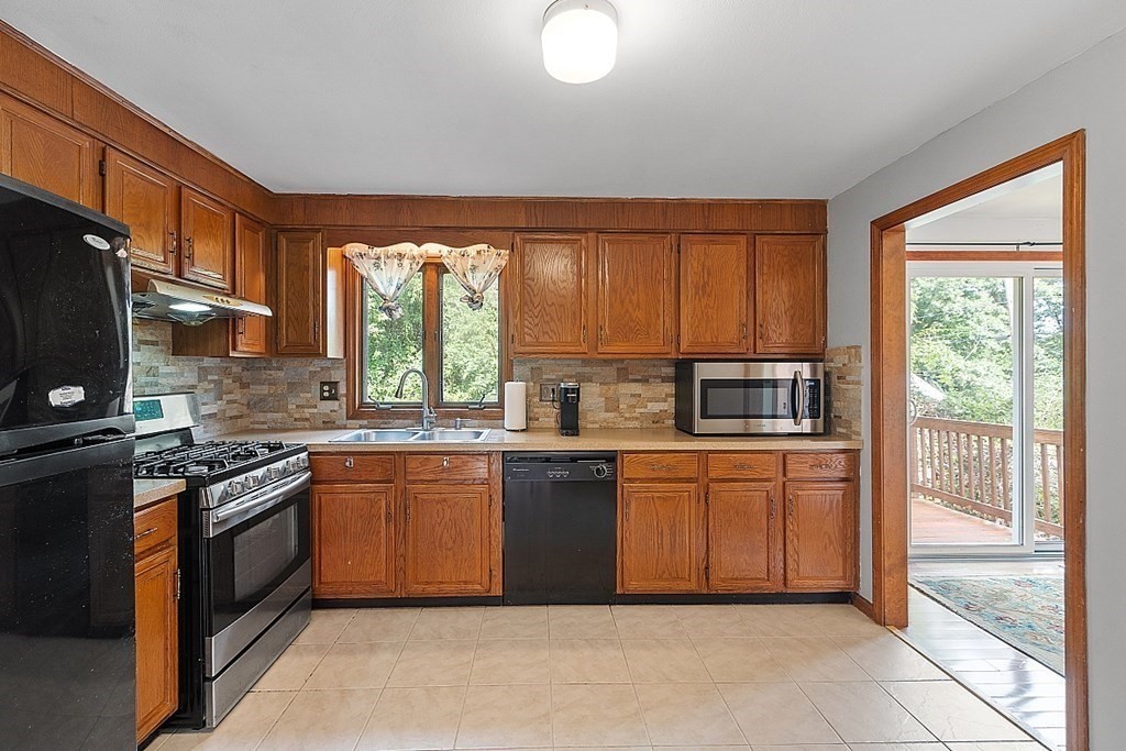 97 Riverview Boulevard Methuen, MA 01844 - Photo 9 of 30 a kitchen with stainless steel appliances granite countertop a stove a sink dishwasher and a refrigerator