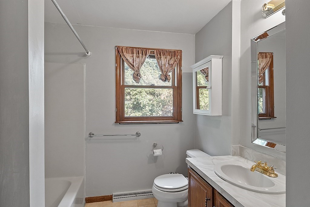 97 Riverview Boulevard Methuen, MA 01844 - Photo 10 of 30 a white toilet sitting next to a bathroom sink