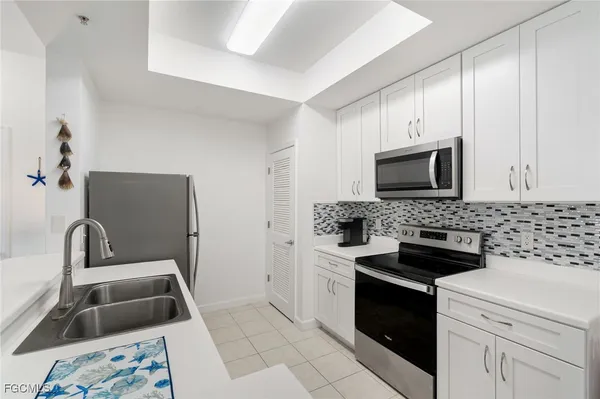 a kitchen with a sink stove and microwave