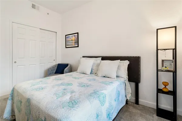 a large bed in a white room