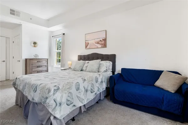 a bedroom with a bed and a couch