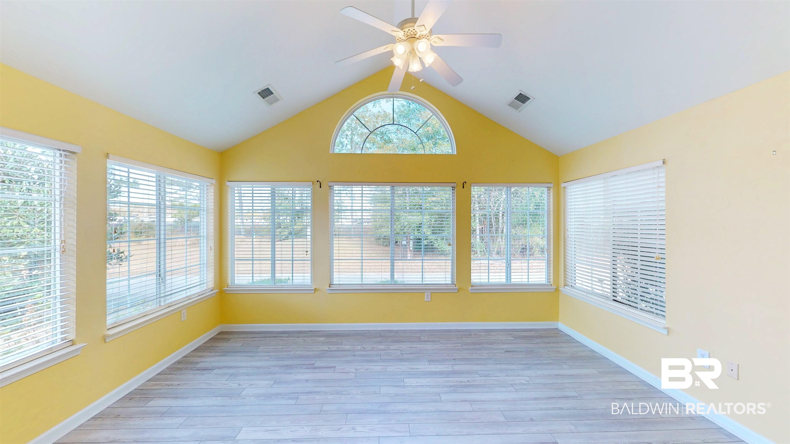 303 Wyld Palms Drive, Unit 303 Foley, AL 36535 - Photo 8 of 36 Unfurnished sunroom featuring vaulted ceiling and wood finished floors