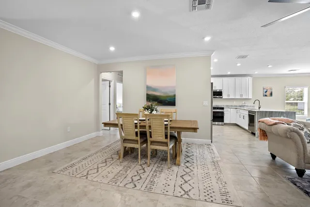 a living room with furniture a flat screen tv and a large window