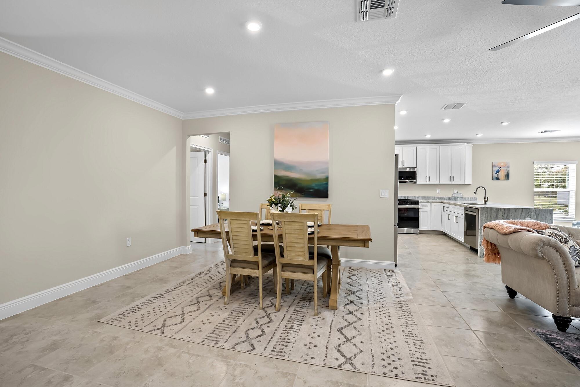 418 Easy Street Sebastian, FL 32958 - Photo 17 of 42 a living room with stainless steel appliances furniture a rug and a kitchen view