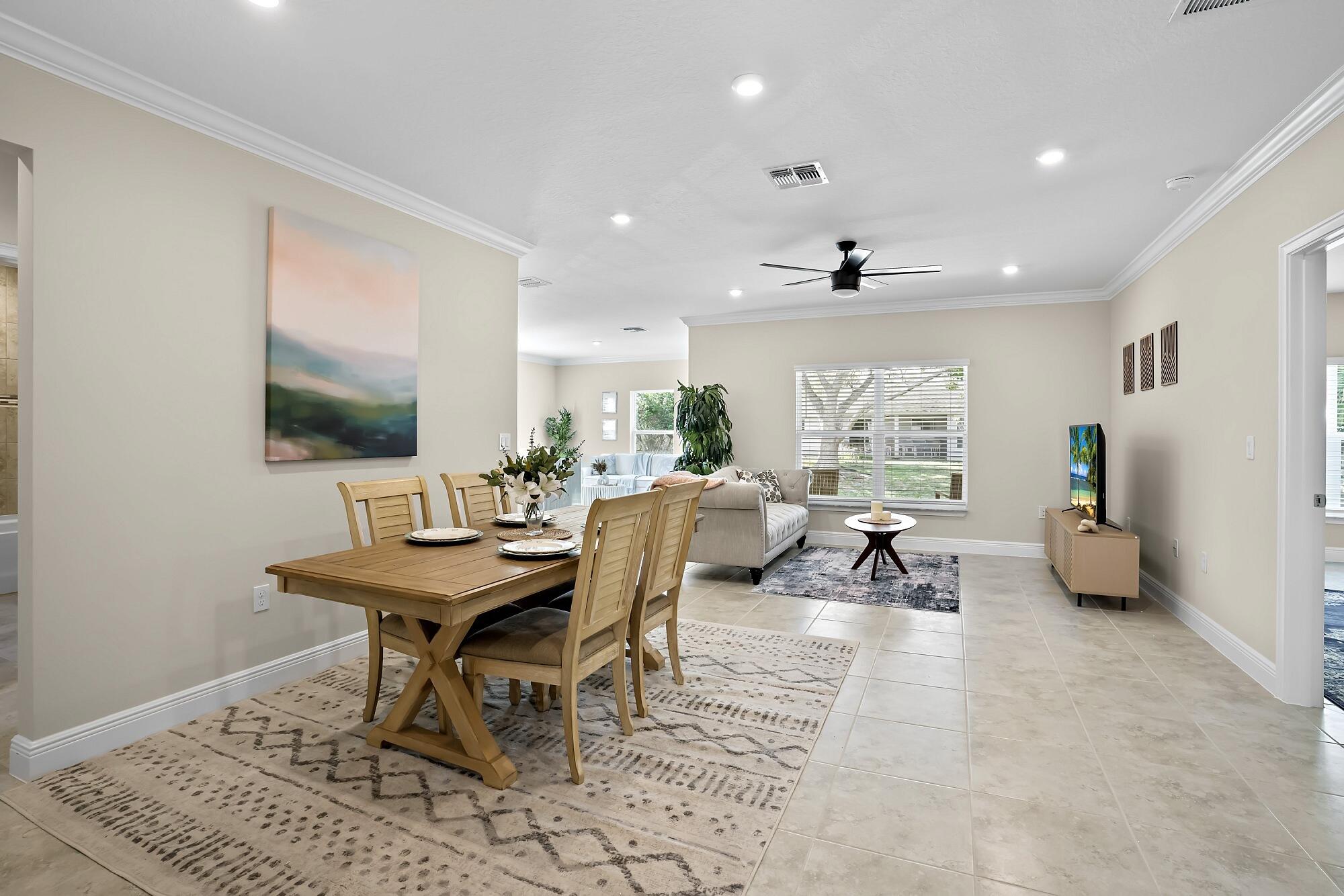 418 Easy Street Sebastian, FL 32958 - Photo 18 of 42 a living room with furniture a flat screen tv and a large window