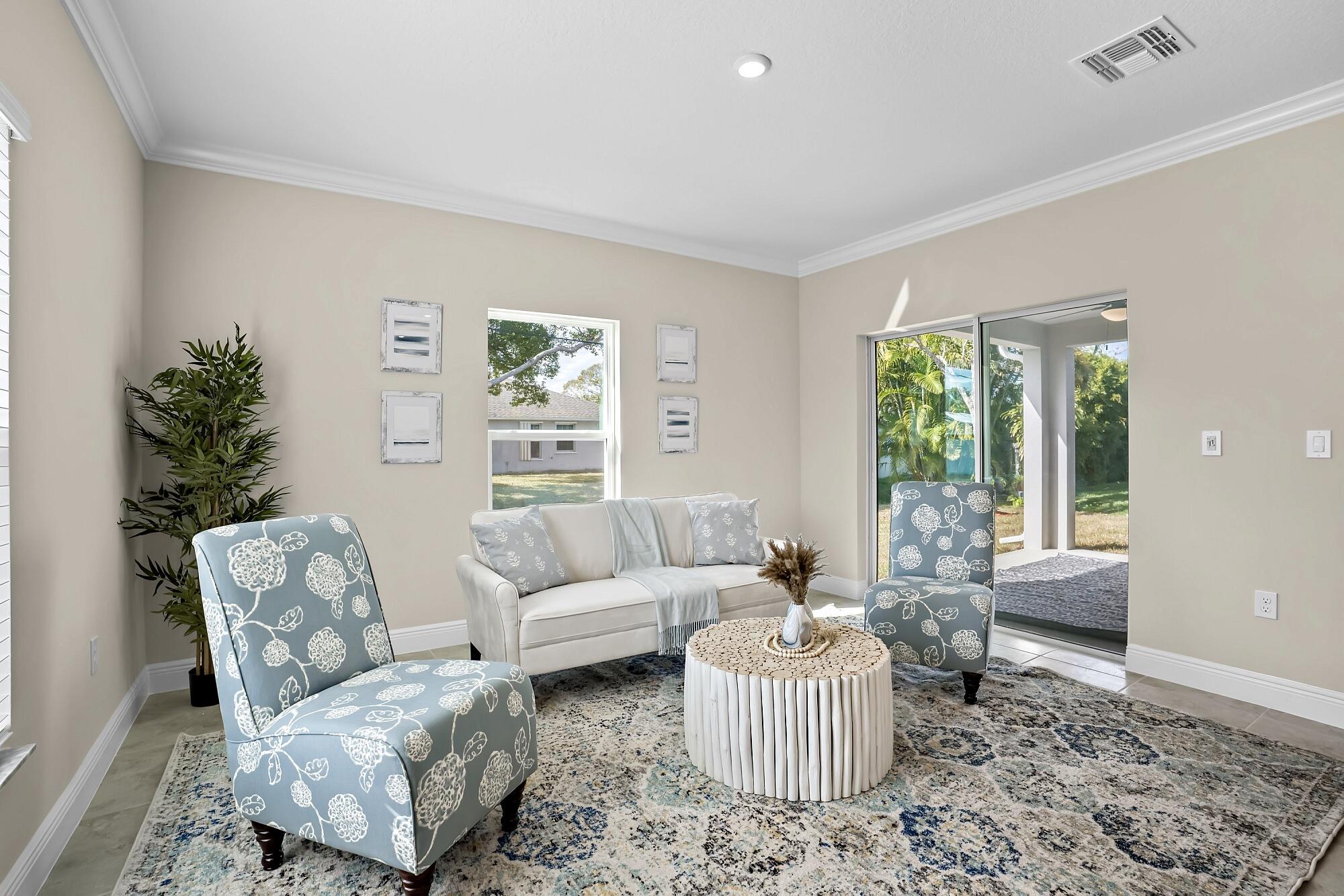 418 Easy Street Sebastian, FL 32958 - Photo 21 of 42 a living room with furniture and a large window